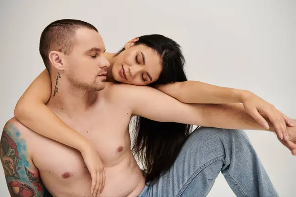 A young couple expresses deep affection in a cozy studio, capturing a moment of romance. — Stock Photo