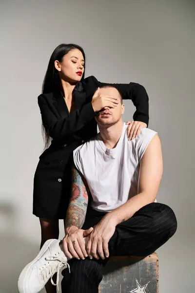 A beautiful young couple poses in a studio, showcasing their love and fashion on Valentines Day. — Stock Photo