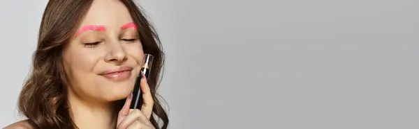 Young woman showcases her unique style with vibrant pink eyebrows and a confident smile, banner — Stock Photo