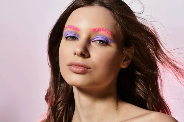 Junge Frau präsentiert ihr atemberaubend kühnes Make-up in einem stilvollen Studio-Setting. — Stockfoto