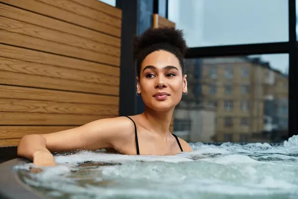 A beautiful young woman relaxes in a soothing spa, embracing tranquility and wellbeing. — Stock Photo