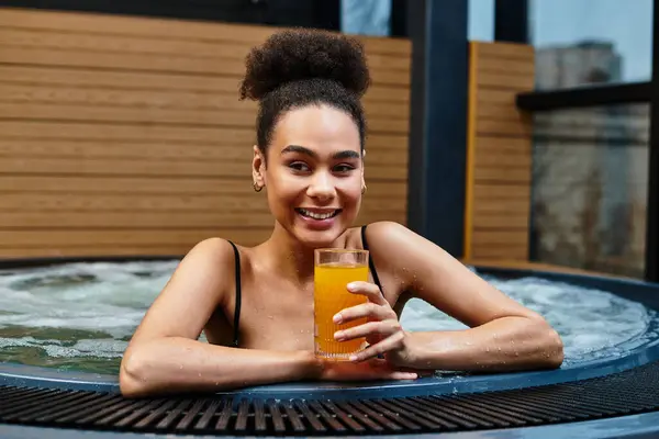 Young woman enjoys a refreshing drink while relaxing in a spa, embracing tranquility and bliss. — Stock Photo