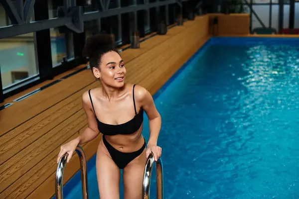A beautiful young woman relaxes at the spa, enjoying a moment of tranquility by the pool. — Stock Photo