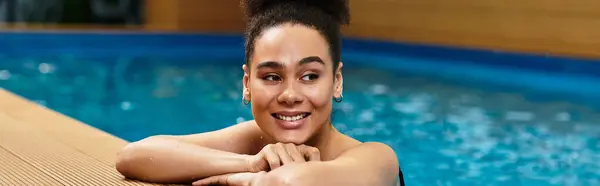 A joyful young woman finds tranquility at a luxurious spa, embracing relaxation by the poolside. — Stock Photo