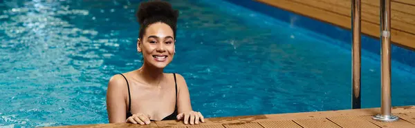 A young African American woman enjoys a moment of relaxation in a serene spa environment. — Stock Photo