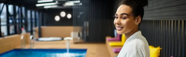 A young african american woman enjoys a sense of peace and relaxation at the spa poolside, glowing. — Stock Photo