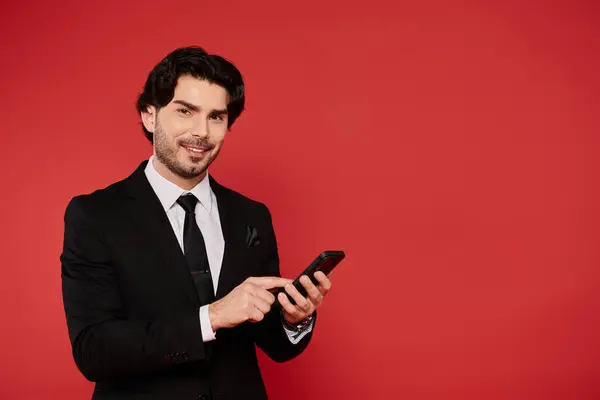 A stylish young man dressed in formal attire displays confidence while checking his phone. — Stock Photo