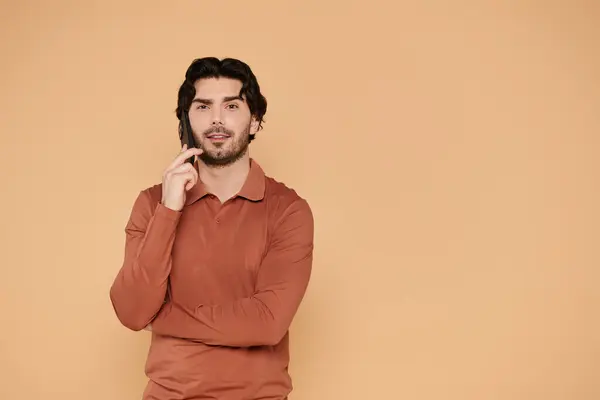 Brunette man stands with a thoughtful expression, showcasing his style in a cozy setting. — Stock Photo