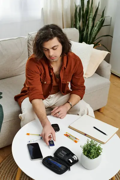 Caucasian man manages his diabetes routine surrounded by essential tools at home. — Stock Photo