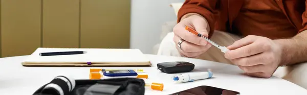 In a modern apartment, a young man prepares insulin while maintaining his daily lifestyle, banner — Stock Photo