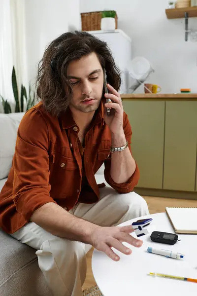 Caucasian man discusses his diabetes management over the phone while at home. — Stock Photo