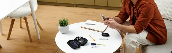 Young man actively monitors his diabetes while engaged in daily tasks at home, banner — Stock Photo