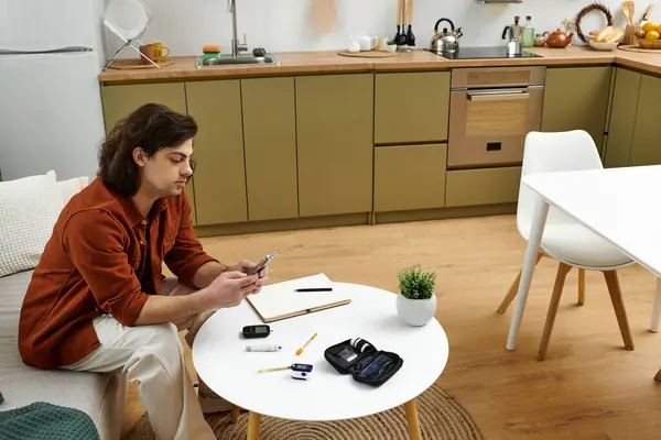 A young man engages in his daily routine while monitoring his diabetes at home. — Stock Photo