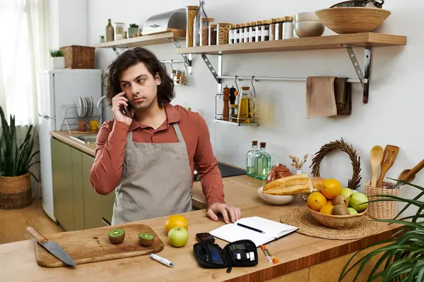 Young man manages his diabetes while preparing healthy meals at home in a stylish space. — Stock Photo