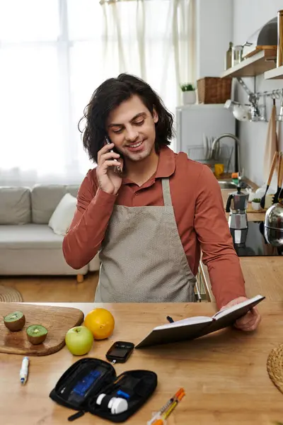 Young man checks blood sugar while enjoying healthy snacks and balancing his daily routine. — Stock Photo