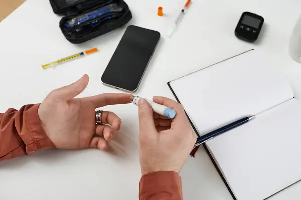 Young man takes care of his diabetes routine at home, maintaining a healthy lifestyle. — Stock Photo