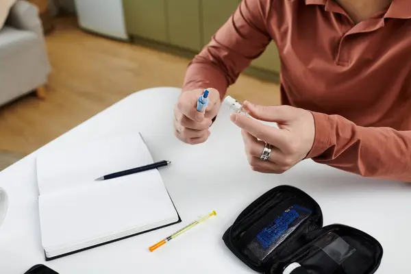 A young man with diabetes prepares insulin while documenting his daily routine at home. — Stock Photo