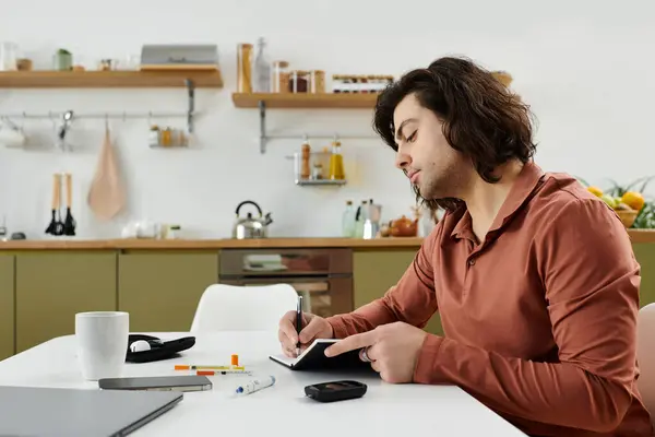 Caucasian man with long hair tracks his health routines at a modern apartment table. — Stock Photo