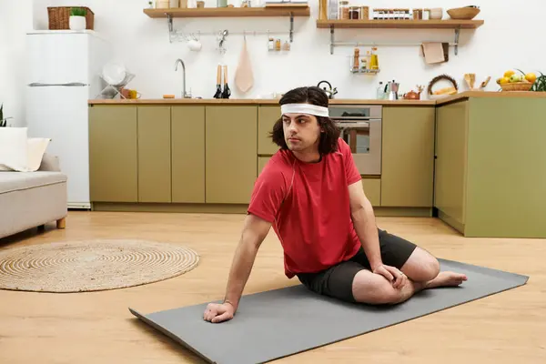 Young man practices fitness routines at home, showcasing his healthy lifestyle in style. — Stock Photo