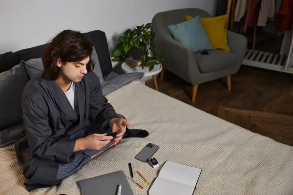 A young man manages his diabetes at home while checking his blood sugar levels with focus. — Stock Photo
