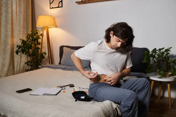 Young man checks his blood sugar and administers insulin in his modern living space. — Stock Photo