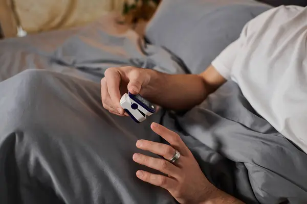 Daily routine of a young man with diabetes as he checks his blood sugar at home. — Stock Photo
