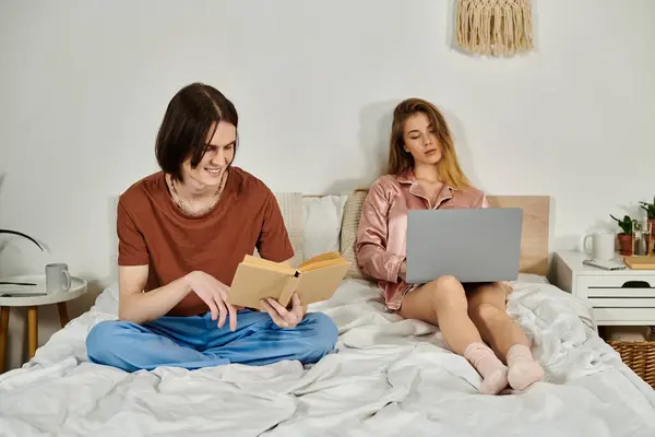 Young adults relax together in a cozy bedroom, engaging in their own activities. — Stock Photo