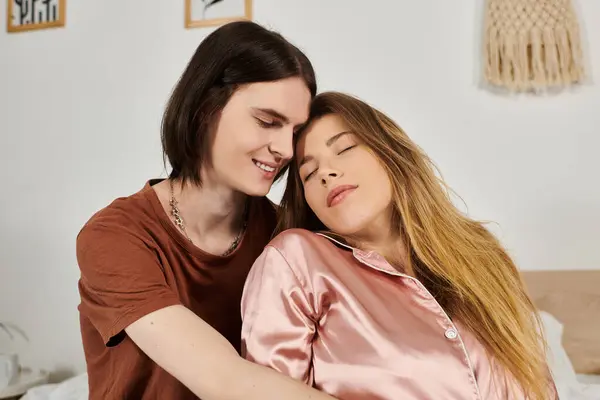 Two young individuals enjoy a tender moment together, surrounded by a warm, inviting atmosphere. — Stock Photo