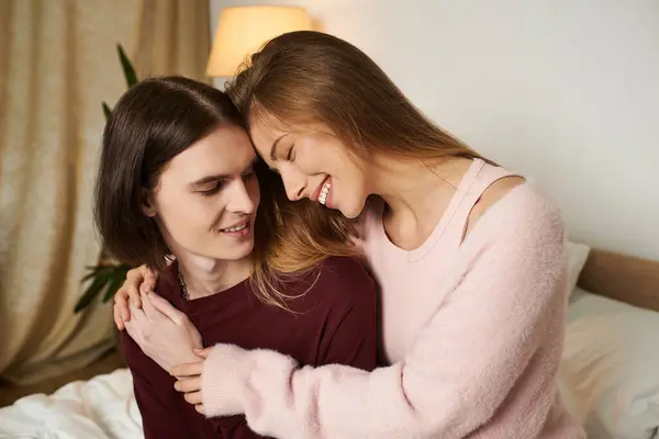 Warm smiles and laughter fill the air as a young couple enjoys their cozy time together. — Stock Photo