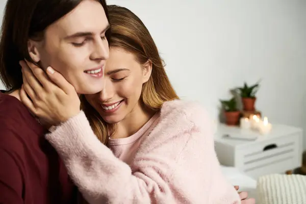 Two young adults share a tender moment filled with joy and affection in a stylish setting. — Stock Photo