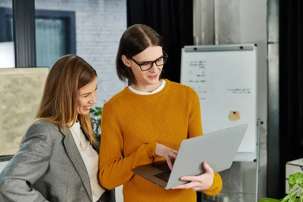 Two young people collaborate in a creative discussion in a modern workspace. — Stock Photo