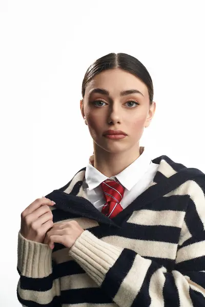 Young woman wearing a striped sweater and tie reveals her emotions through a captivating gaze. — Stock Photo