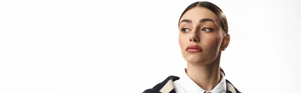 A young, beautiful woman showcases her emotions while posing in a bright studio environment. — Stock Photo
