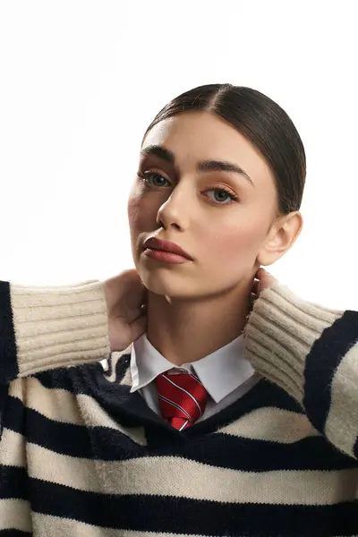 A young woman with elegant features adjusts her collar while reflecting deep emotions. — Stock Photo
