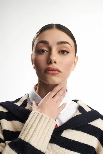 A young woman gazes thoughtfully while touching her neck, showcasing her beauty and emotions. — Stock Photo