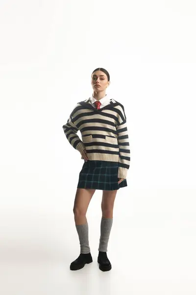 A young woman showcases her unique fashion sense while exuding emotion in a simple setting. — Stock Photo
