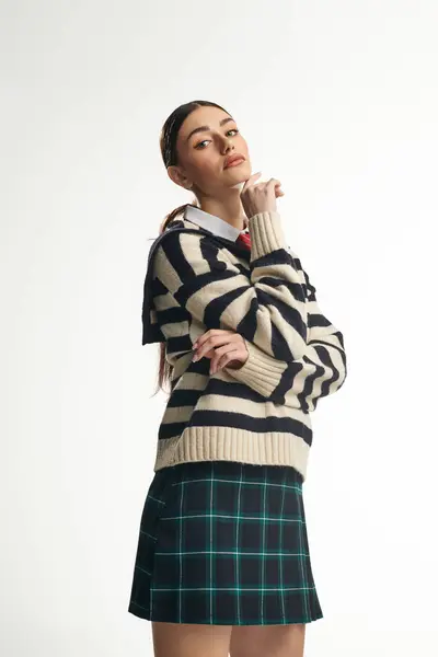 A young woman embodies elegance and emotion while showcasing trendy attire with a thoughtful pose. — Stock Photo