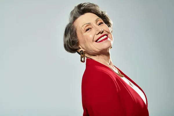 Mature woman showcases timeless beauty in stylish attire, radiating elegance and charm. — Stock Photo