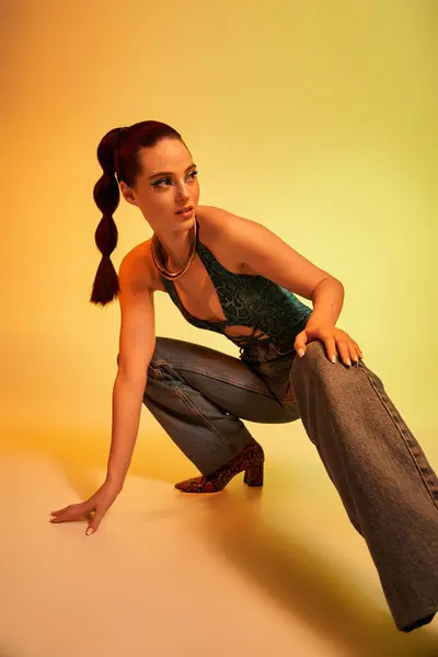 Young woman in snake print attire poses stylishly, showcasing her makeup and confidence. — Stock Photo