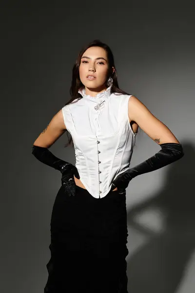 A young woman with shiny brown hair poses confidently in an elegant outfit. — Stock Photo