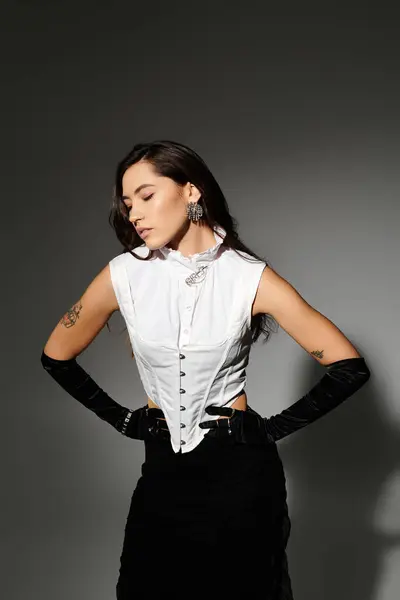 In a modern studio, a young woman showcases her fashion sense with confidence and elegance. — Stock Photo