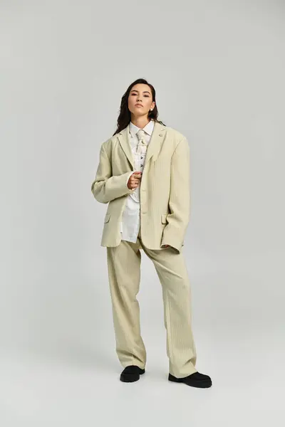 A young woman proudly showcases modern elegance in her stylish outfit. — Stock Photo