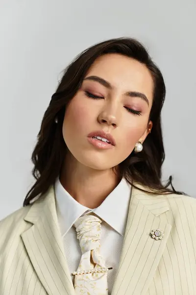 A beautiful young woman showcases her fashionable attire with a calm demeanor, highlighting grace. — Stock Photo