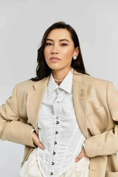 Elegant young woman showcases her fashionable outfit in a modern indoor space on a bright day. — Stock Photo