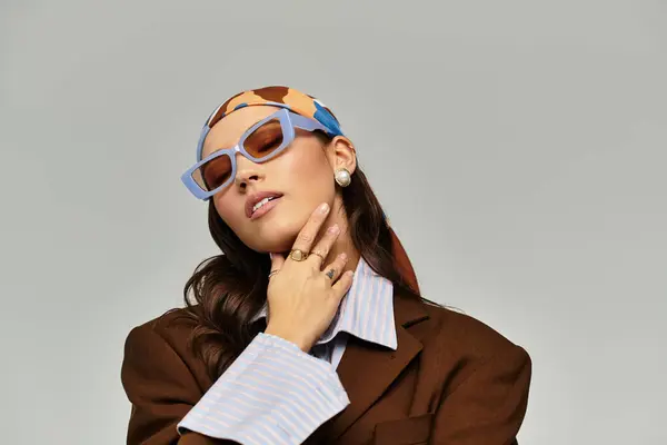 This young woman exudes style and confidence with chic accessories in a trendy space. — Stock Photo