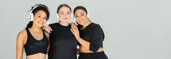 Three confident women celebrate their fitness journey together, showcasing style and strength. — Stock Photo