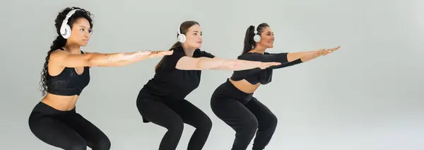 Three strong women squat together in a modern gym, showcasing unity and fitness. — Stock Photo