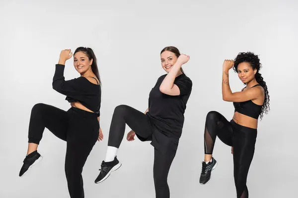 Three women display their strength and confidence while engaging in a fitness routine together. — Stock Photo