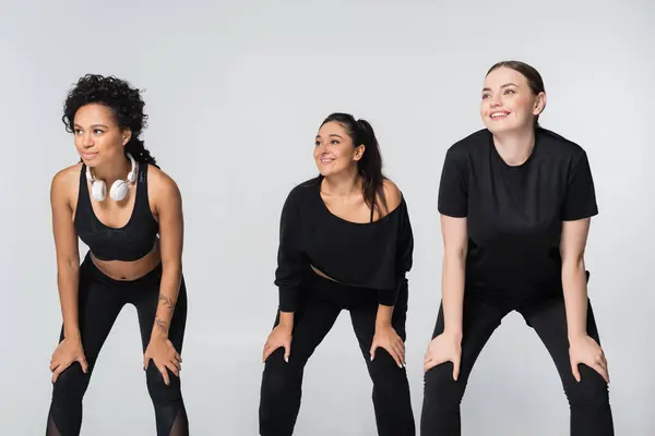 Three fit women confidently train together in stylish workout gear. — Stock Photo