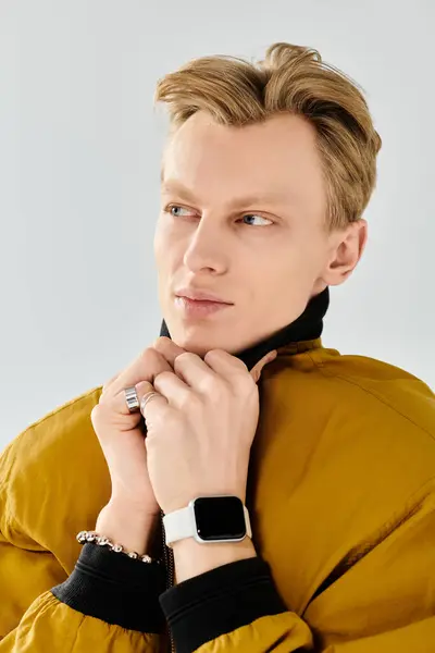 A young handsome man with stylish hair is posing thoughtfully, showcasing his fashionable jacket. — Stock Photo